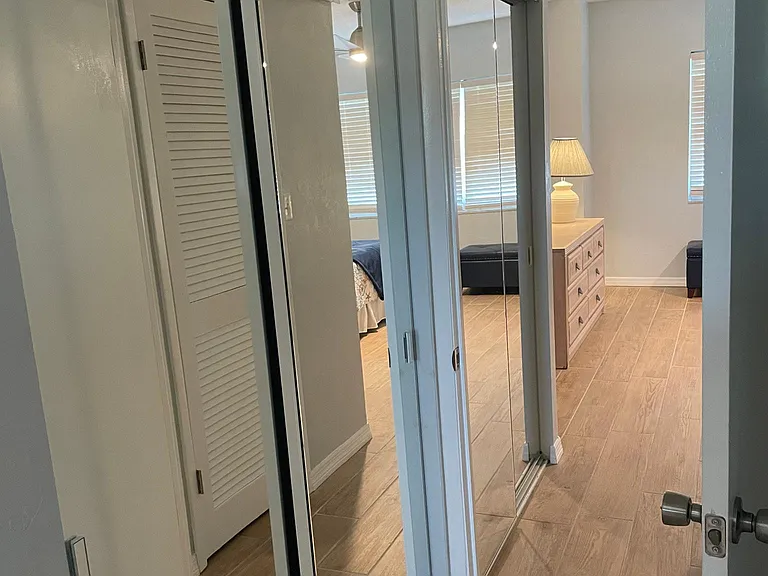 Hallway between bedrooms mirrored closet space