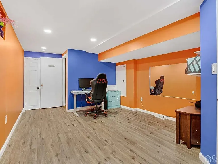 Basement office room with lot of storage closet