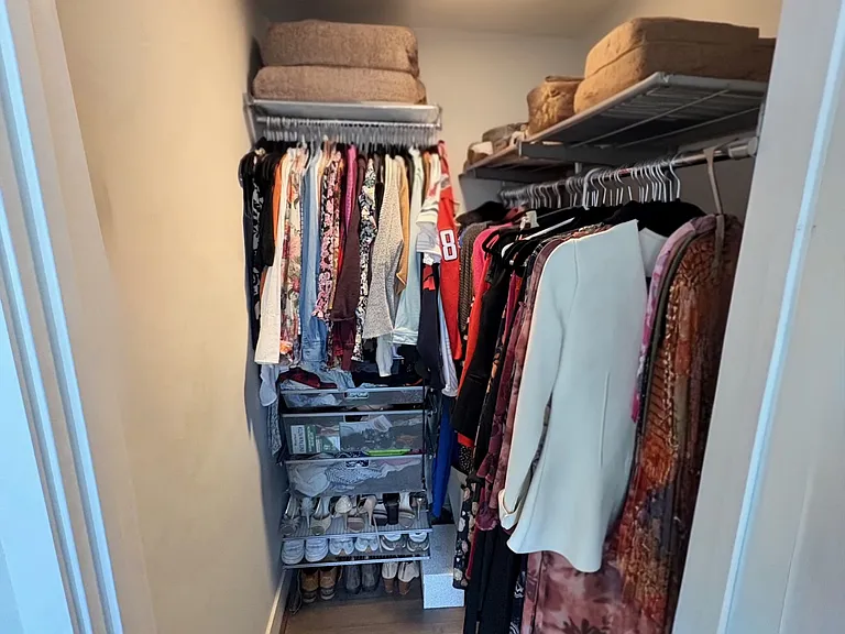 Primary walk in closet, comes with Elfa closet storage and organization.