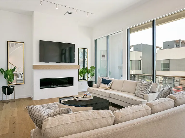 Open concept living room offering an inviting setting for relaxing and entertaining. Also has access to 2nd floor patio space.