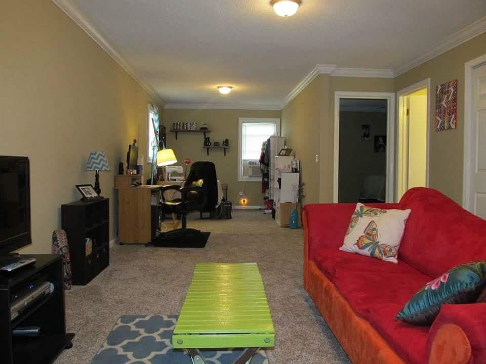 Living room open floor space to office area.