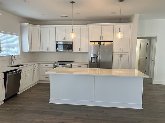 open concept kitchen/dining area; view from back door entrance