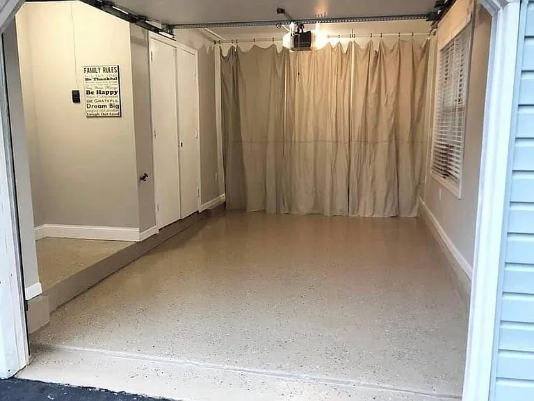 Finished garage. Storage space behind curtain. Utility closet behind doors. Powered Garage Door with remote & key pad.