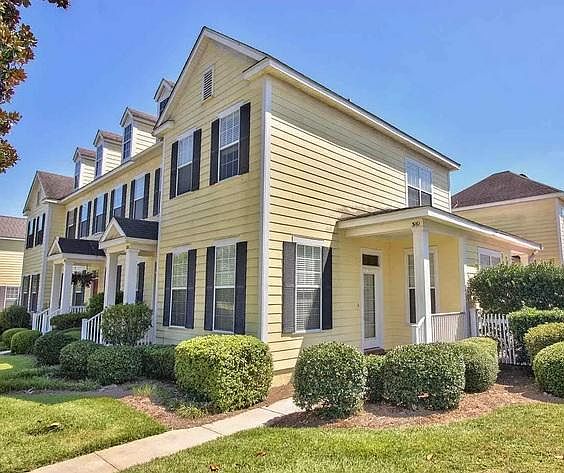 Exterior, front. This is an end unit with a beautiful yard