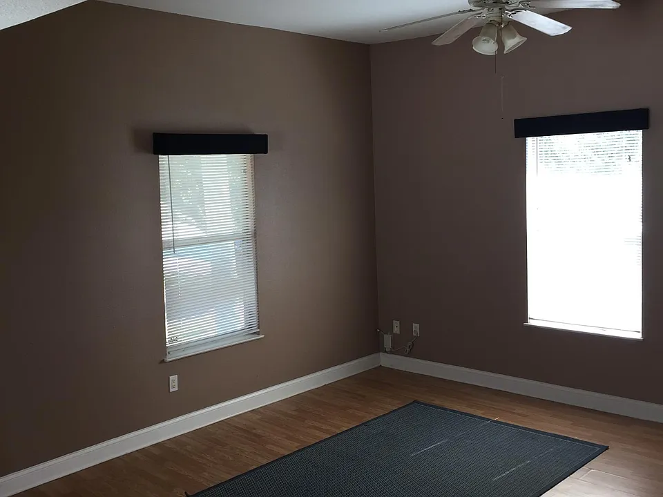 Spacious living room with plenty of light. Wood flooring