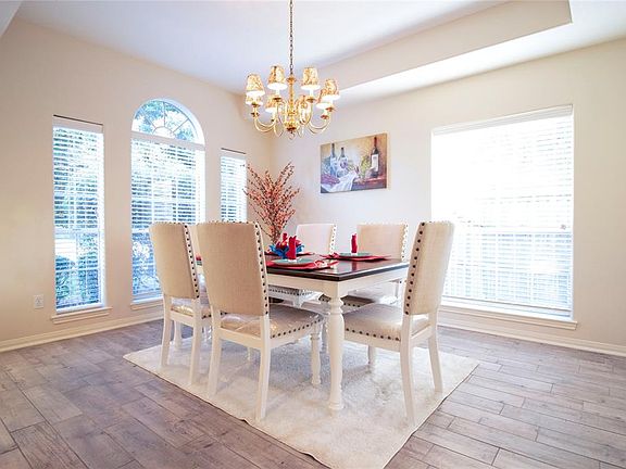 Make memories gathered around the table with your family and friends! This dining room features high ceilings, large windows, and a beautiful chandelier!