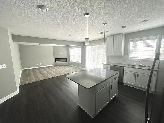 Open concept kitchen and living room with walk-out patio