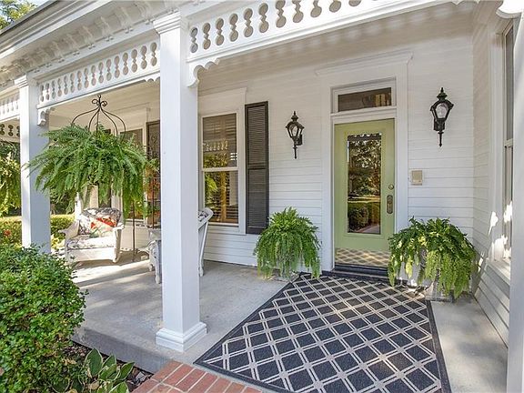 Relax on this charming front porch and notice the detail of the structure