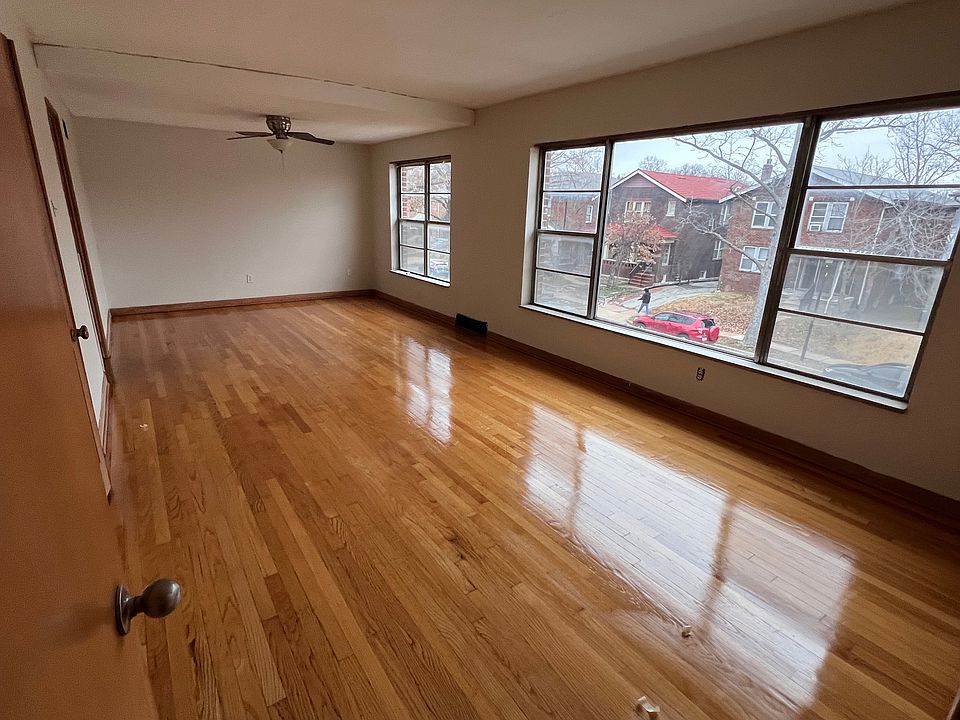 Spacious combined living and formal dining rooms with expansive windows offering views of Heman Park.

There is a storage closet tucked in above the front entry staircase.