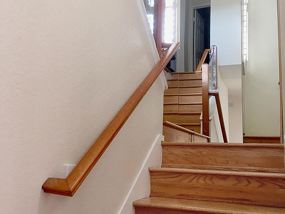 Staircase with floor to ceiling mirror.