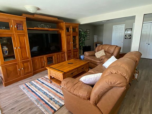 Living room with entertainment center - all chairs recline with footrests