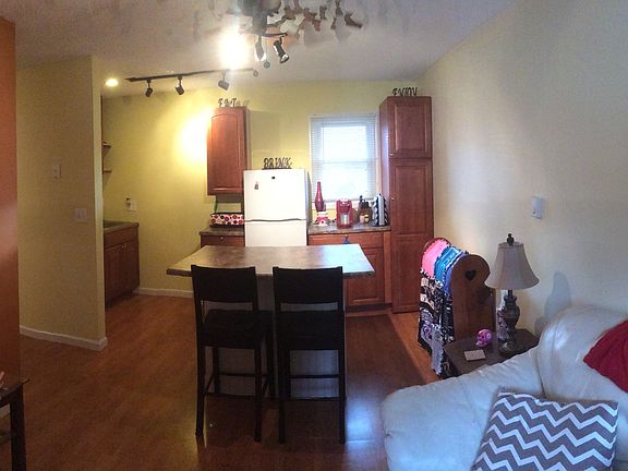 Living and kitchen view from entry. Note the wall colors may not be the same as this unit. Each one has different colors.