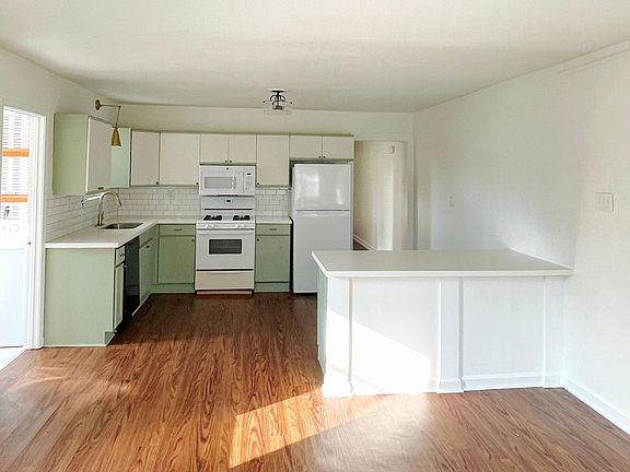 Living/Kitchen Open Concept. Laundry Room and backyard access to the Left. Hallway to bathroom and 2 bedrooms.