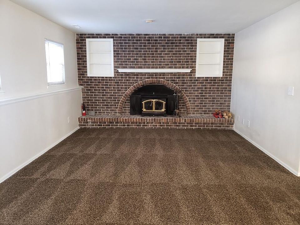 Downstairs living room with working fireplace and windows