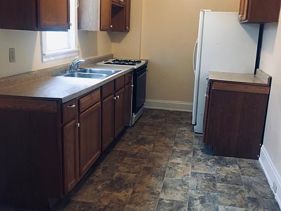 Kitchen with back door to porch and back yard.