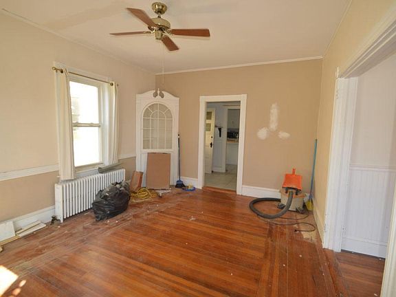 A built-in hutch adds charm to a the living room space. To the right a new bathroom is being added. This rental will be clean and ready for move in on January 1, 2021!