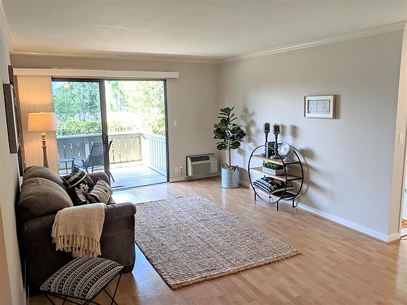 Living Room with Laminate Flooring and Crown Molding
