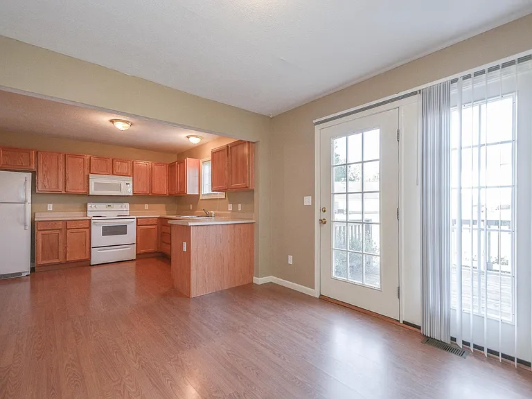 Actual kitchen has a more modern vinyl floor compared to the one depicted in the picture.