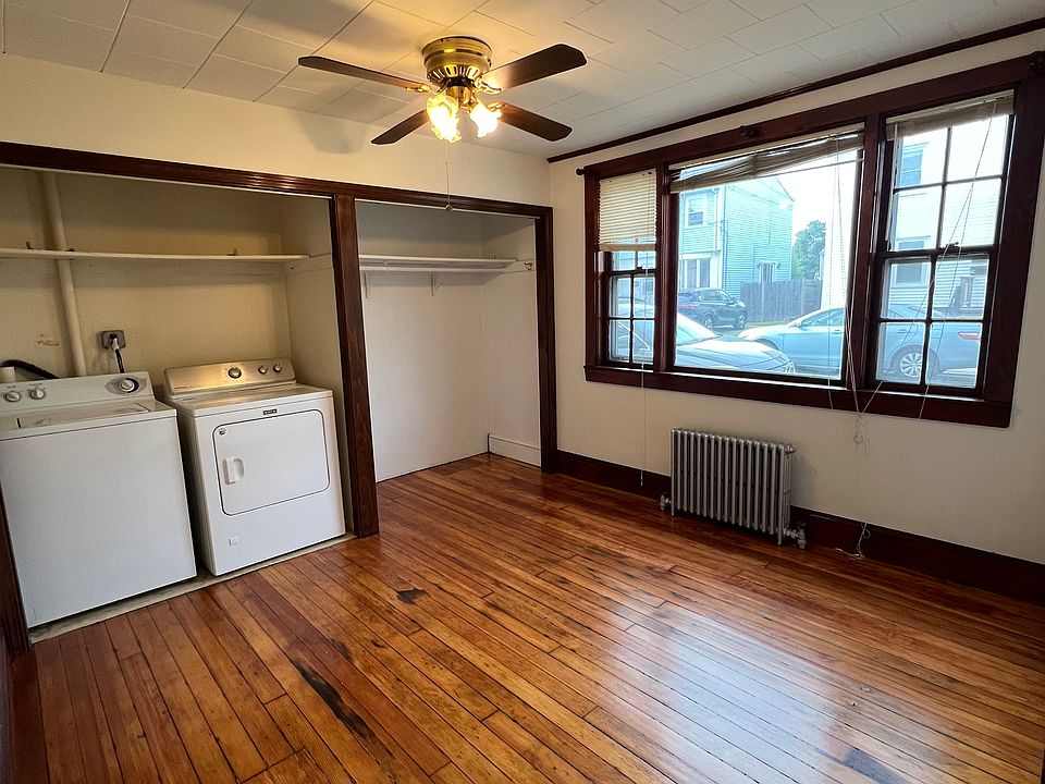 Second bedroom with washer dryer. There are beautiful wooden closet doors the color of the trim above the closets. Plenty of storage in the double closet.