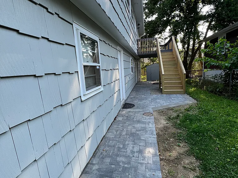 Right hand side of the house little bit far way.