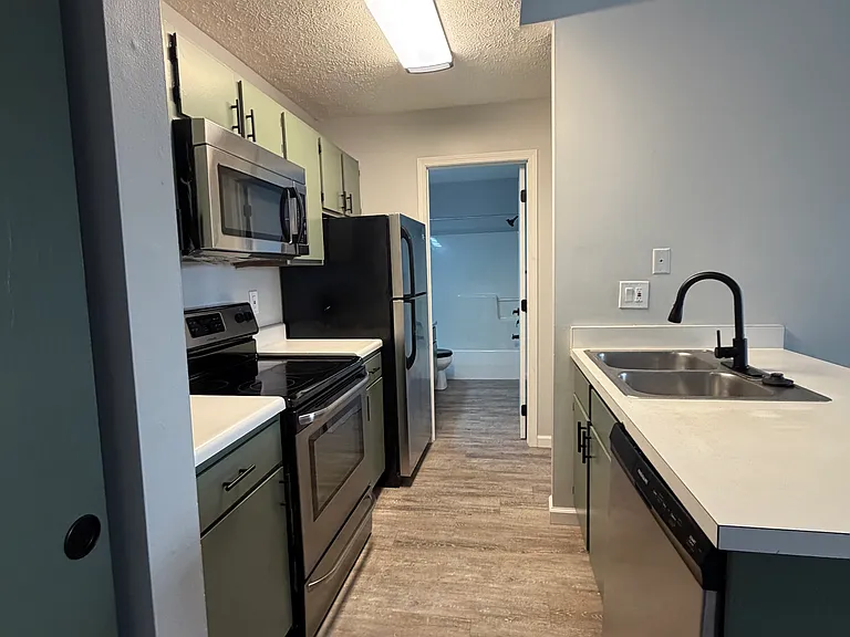 View of kitchen floor and appliances.