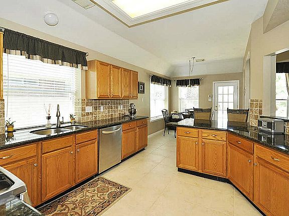 Great flow for parties! Kitchen features stainless steel sink, microwave, oven, five burner gas range. Large pantry area. Kitchen designed for mom to manage the household & keep up with the kids!