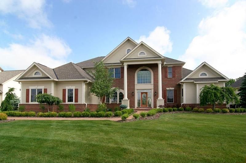 Stunning executive home in Muirfield w/custom finishes & details throughout