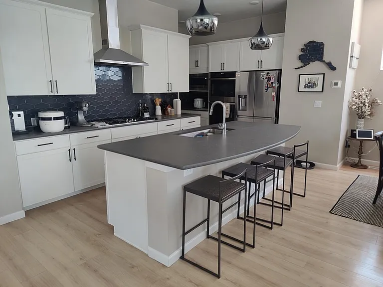 Chef's Kitchen with 5-burners gas stove, stainless steel hood, double oven, built-in microwave, refrigerator, and dishwasher