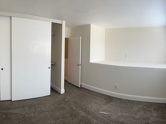 Smaller bedroom; 2 closet doors with Elfa closet organizers. Bedroom was recently made more private by walling-off the staircase below.