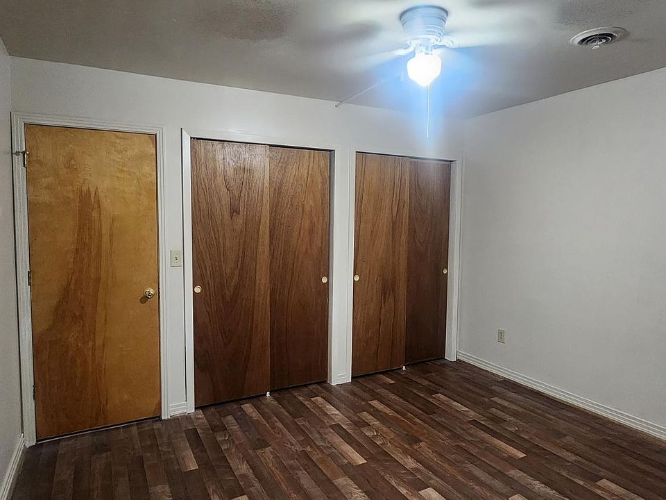 Master Bedroom with Double Closet and Back Exit Door leading out to the community deck.