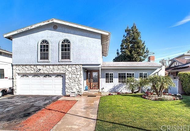 This home features handsome curb appeal, dual pane windows, composition roof, RV parking, wrought iron gates, and direct access from the house to the two car garage.