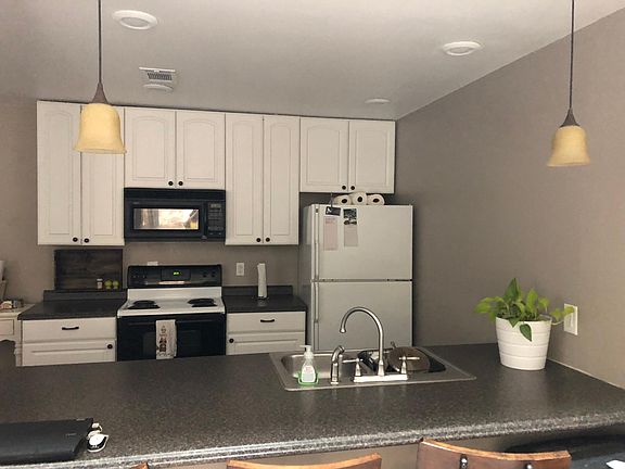 Bright kitchen with microwave and dishwasher.