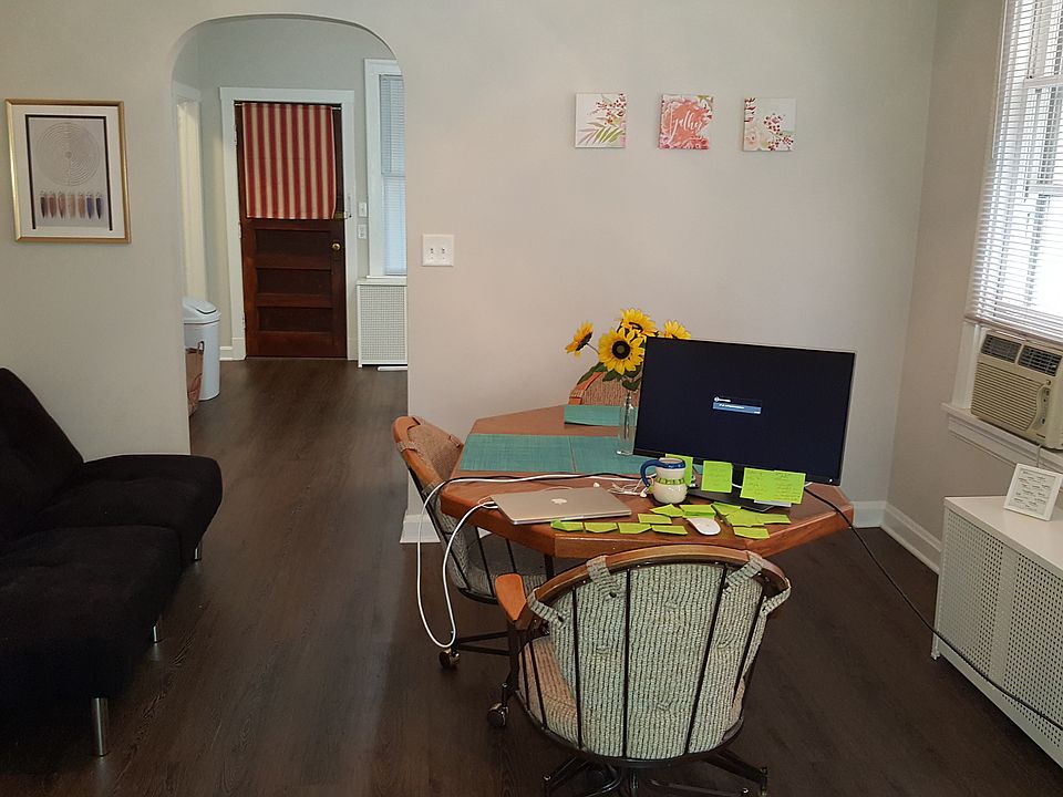 Dining room view to kitchen and back door with updated laminate flooring.