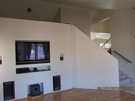 Living room with built in television and surround sound.