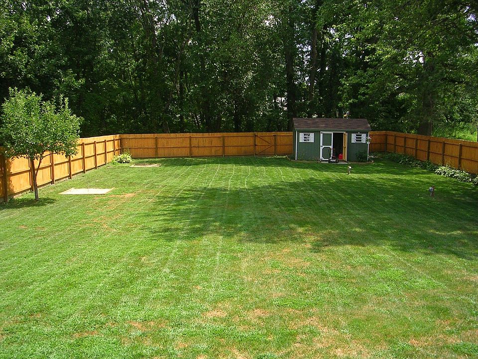 large backyard with new cedar stained fence