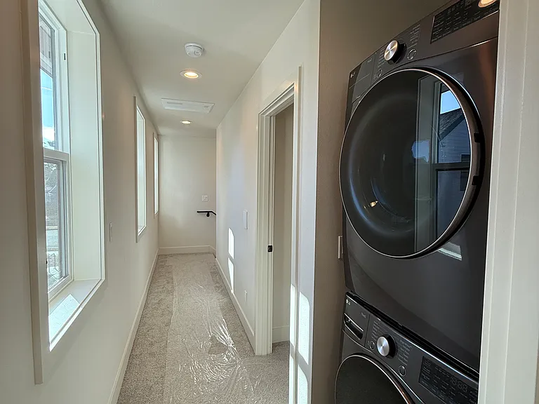 Upstairs hallway w/ washer and dryer.