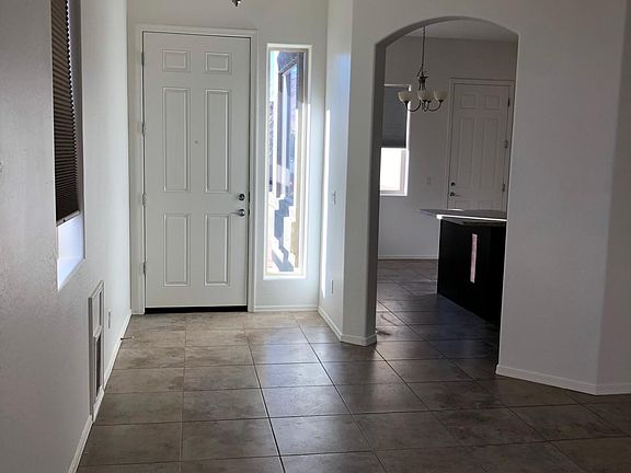 Looking toward front door and kitchen from living room