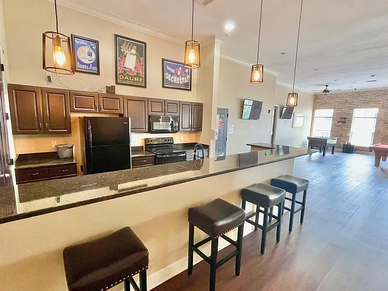 Clubhouse Kitchen with full fridge, range, microwave, and sink