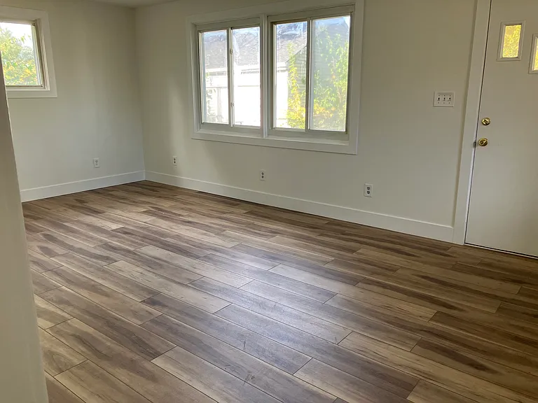 Large family room off the kitchen with a door that leads to the fenced in yard.