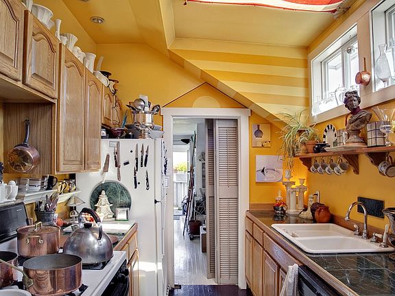 Upper unit bedroom with glass french doors to an attached deck.