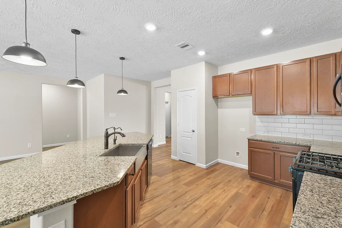 Spacious open kitchen open to dining area and living space. New black refrigerator will be provided. - 3876 Tolby Creek Ln