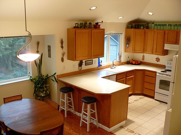 Kitchen with new tile floor and eating area with new hardwood floor