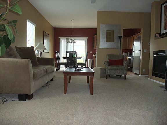 Spacious, open living room with fireplace. (New hard floors not shown)