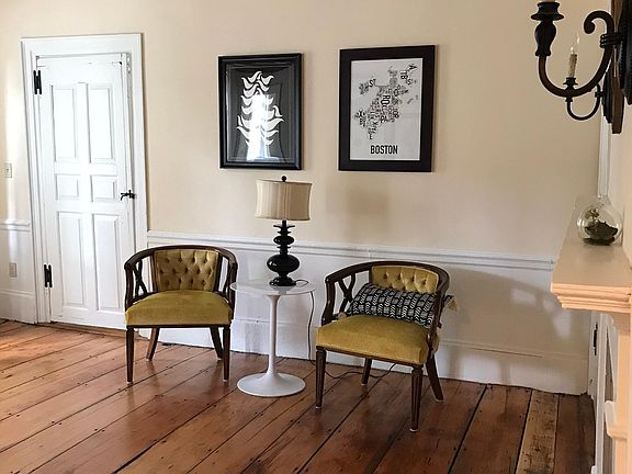 Living room with door leading to front hall and entry and front stairs.