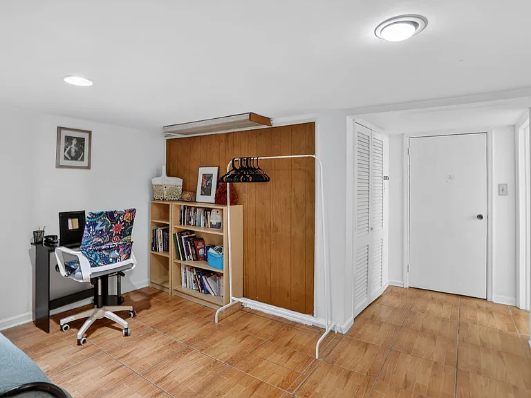 Den/office w/small desk & office chair.