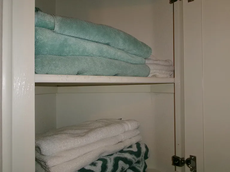 Hall cabinets are stocked with towels.