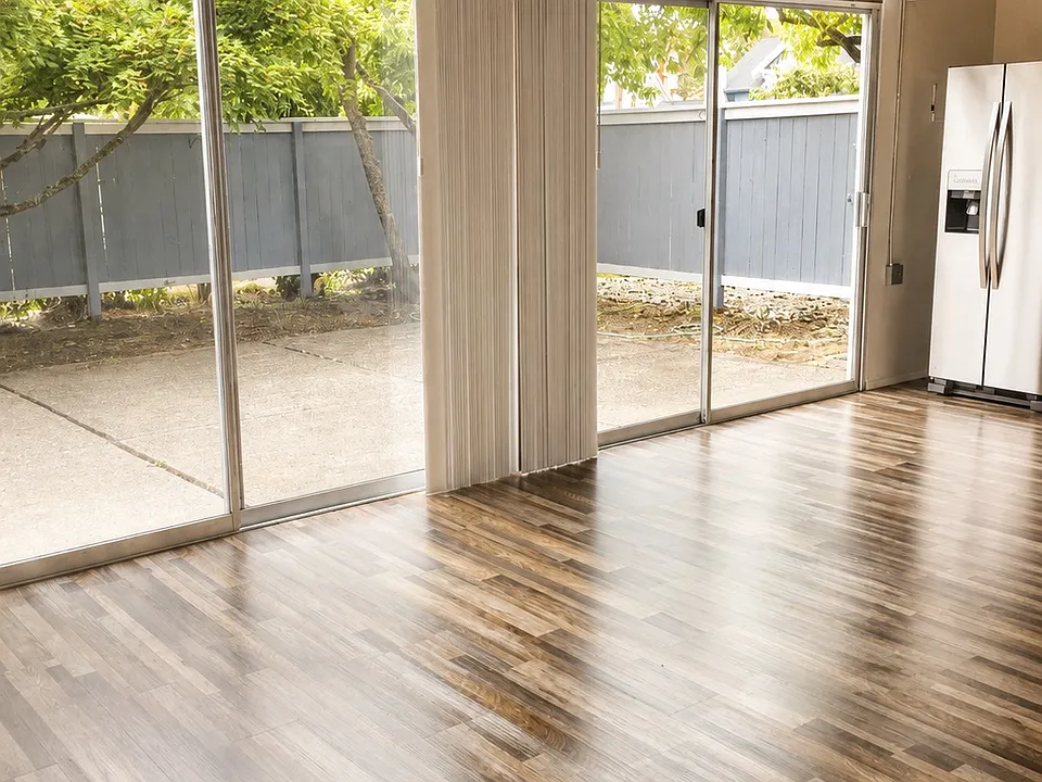 Pulling back the vertical blinds gives floor to ceiling light and a view of the courtyard with privacy fence