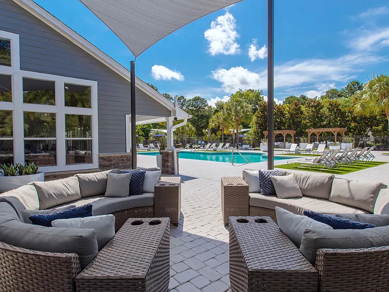 Unwind in style at our poolside outdoor lounge. This shaded retreat features plush seating and offers the perfect ambiance for serene conversations and relaxation.