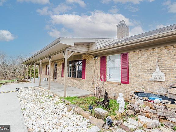 Front of the house showing long Spacious Porch-Wide Concrete Sidewalk from Driveway to front door.