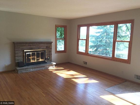 Warm welcome with hardwood floors and fireplace. New Pella windows and home overlooks Brookside Park